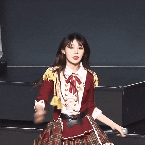 a woman in a red and white outfit is dancing