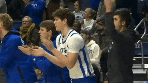 a basketball player wearing a blue and white jersey that says kyu on it