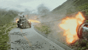 a truck is driving down a road with a fireball coming out of it