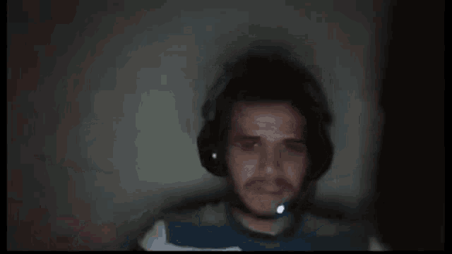 a close up of a person holding a cell phone in their hand in a dark room .