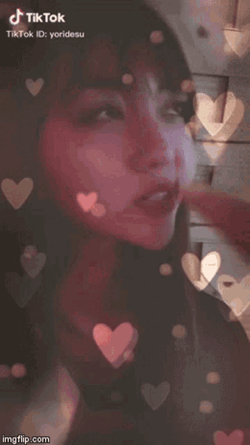 a tiktok video of a woman with hearts around her mouth