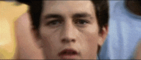 a close up of a man 's face with a blurry background