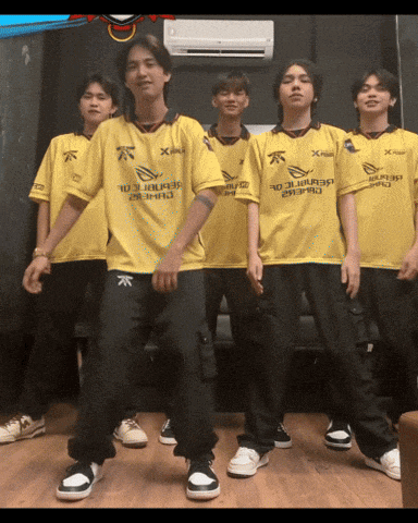 a group of young men wearing yellow shirts with the word x on them are posing for a photo