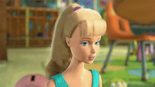 a barbie doll with blonde hair and blue eyes is wearing a blue top