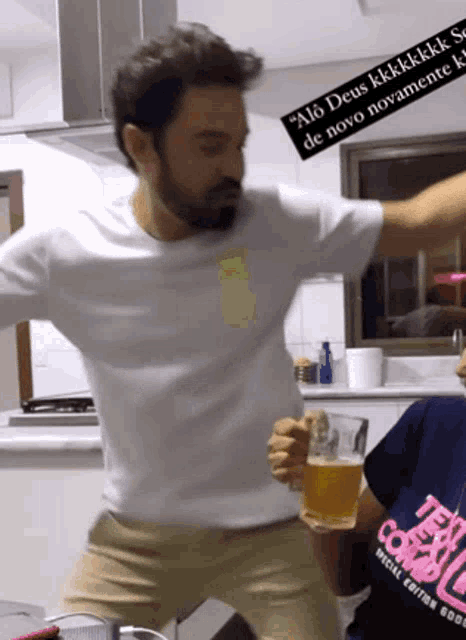 a man in a white shirt is holding a beer