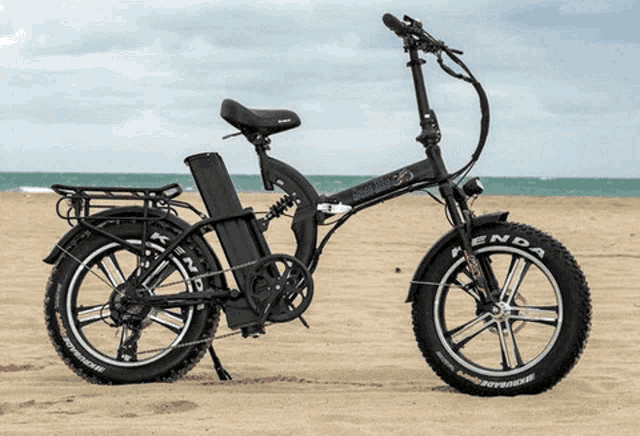 a kenda bicycle is parked on a beach