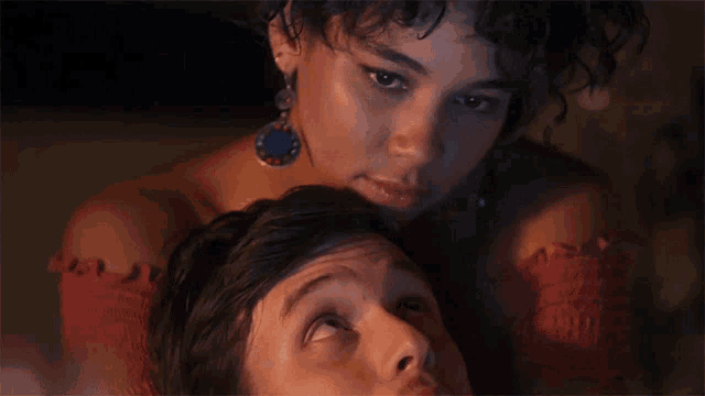 a close up of a woman laying on a man 's neck