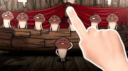 a person 's finger is pointing at a group of mushrooms on a stage