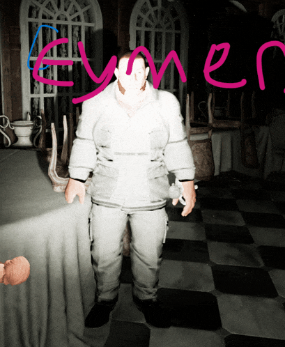a man standing in a room with the word eymer written on the wall
