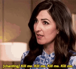 a woman in a blue shirt is saying kill me kill me kill me