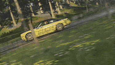 a yellow formula drift car is driving down the road