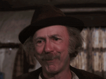 a man wearing a hat and a mustache says but it can be done