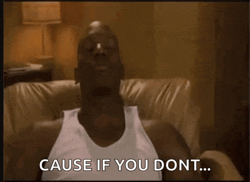 a man in a white tank top sits on a couch and says cause if you dont