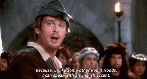 a man in a robin hood costume is talking to a crowd