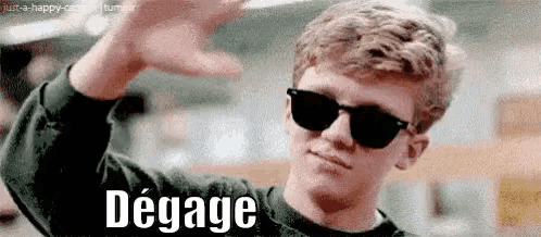 a man wearing sunglasses and a green sweater is waving his hand and the word degage is written below him .