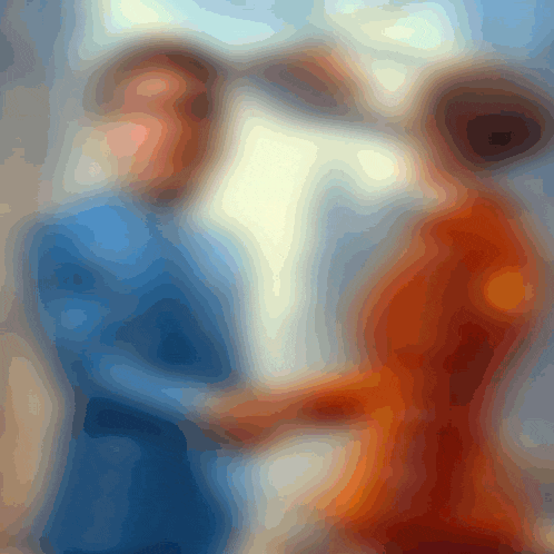 a blurry picture of two people standing next to each other with one wearing a blue shirt