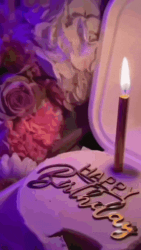 a birthday cake with a candle and the words happy birthday written on it