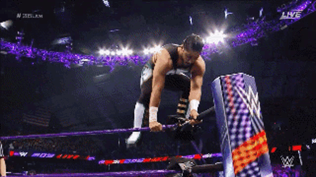 a wrestler in a purple ring with the word live on the bottom