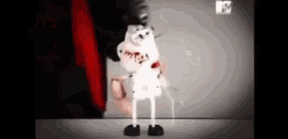 a cartoon character is standing in front of a red curtain with a mtv logo in the corner .