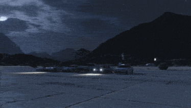 several cars are parked in a parking lot at night