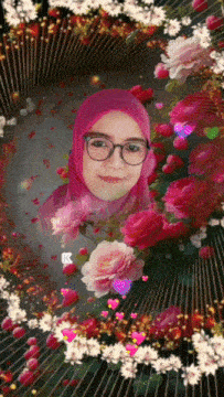 a woman wearing glasses and a pink hijab is surrounded by flowers