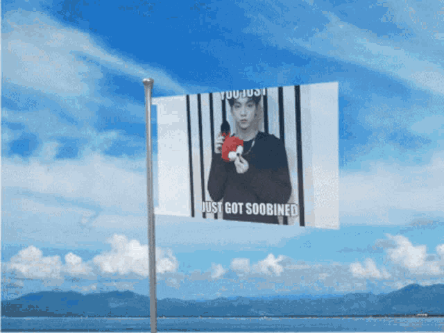 a billboard with a picture of a man holding a heart and the words just got soobined