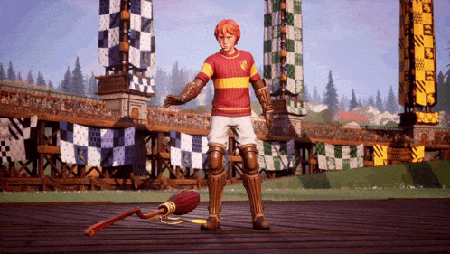 a boy in a gryffindor shirt is standing on a wooden floor with a broom