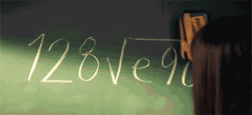 a person is writing on a blackboard that says " 128ve90 "