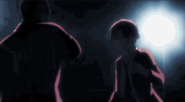 a man in a suit is kneeling in the dark
