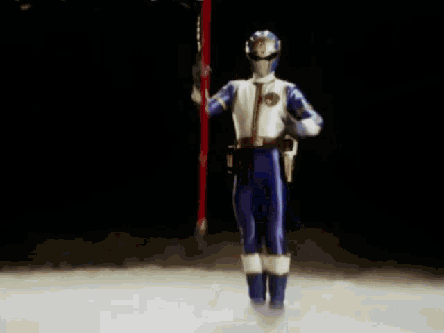a person in a purple and white suit is holding a blue sword