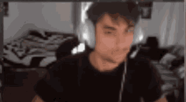 a man wearing headphones is sitting in front of a computer .