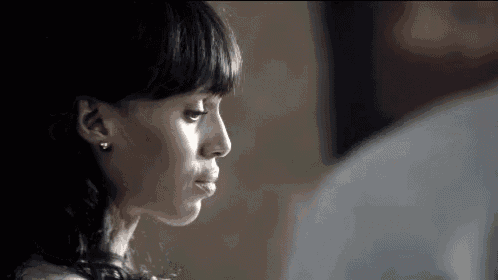 a close up of a woman 's face looking at a man .