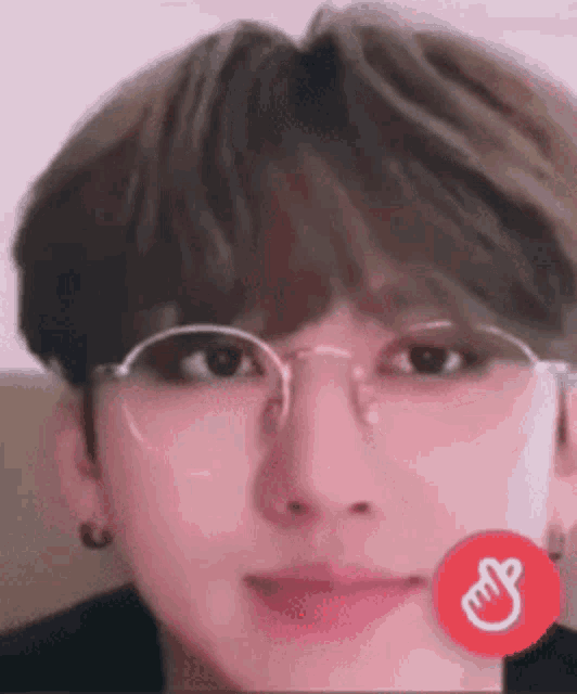a close up of a person 's face wearing glasses and earrings .