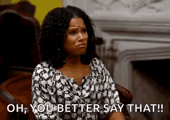 a woman is sitting in a chair and says `` oh , you better say that '' .