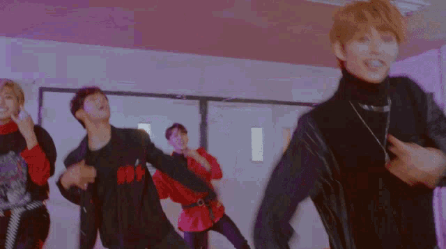 a group of young people are dancing in a hallway with a coke machine in the background