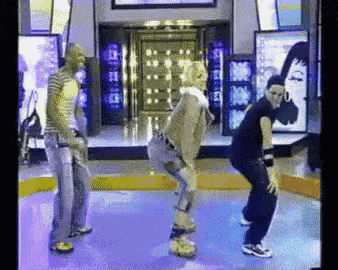 a group of people are dancing on a stage in front of a sign that says ' nbc ' on it