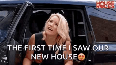 a woman is sitting in the back seat of a car with her mouth open and says `` the first time i saw our new house '' .