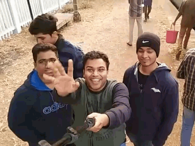 a group of young men are posing for a picture one is wearing an adidas sweatshirt