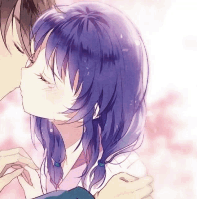 a man and a woman are kissing each other . the woman has purple hair .