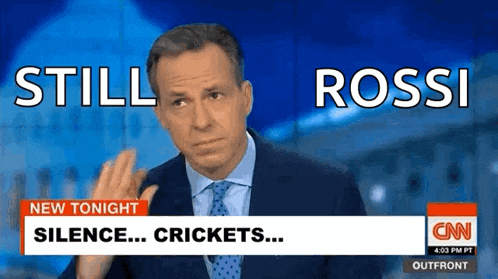 a man in a suit and tie is talking about cricket