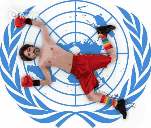 a shirtless man in red shorts and rainbow socks is laying on a united nations symbol