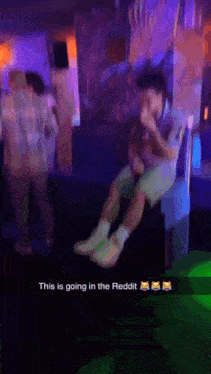 a man is sitting on a couch in a dark room with a caption that says this is going in the reddit