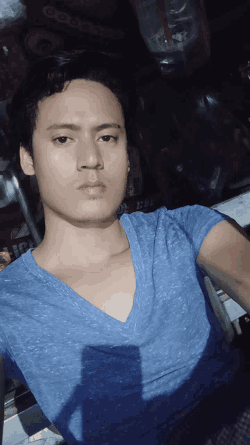 a man in a blue shirt is taking a picture