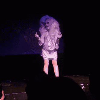 a woman in a white dress is dancing on a stage