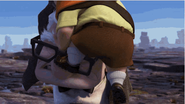 a man with glasses is carrying another man on his shoulders