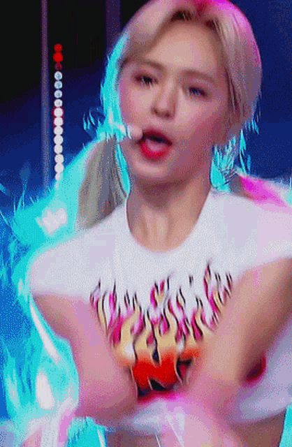 a woman in a white shirt with flames on it