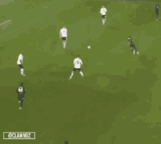 a group of soccer players are playing on a field with a claw n92 logo in the corner