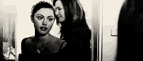 a couple of women are standing next to each other in a room .