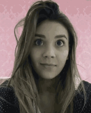 a woman with long hair is making a funny face