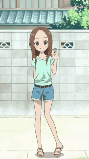 a girl in a green shirt and blue shorts is waving